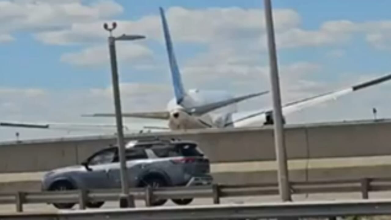 Plane with 221 passengers on board hits a light pole and a truck on a highway during landing