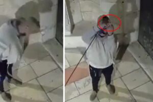 Israeli settler spits on a church and makes rude gestures with the cross symbol