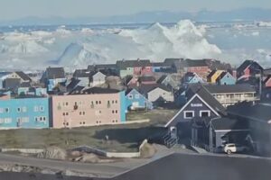 An iceberg capsizes and causes a mini tsunami
