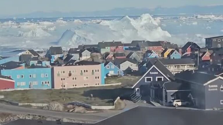 An iceberg capsizes and causes a mini tsunami
